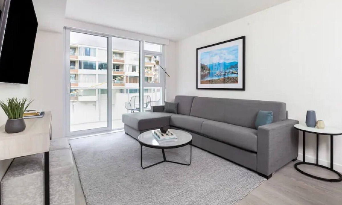 South Lake Union House | Level Seattle- Executive Two Bedroom Suite with separate office space, bedroom with king bed, full kitchen, living & dining area, private balcony, in-suite laundry, modern bathroom with Malin + Goetz amenities.