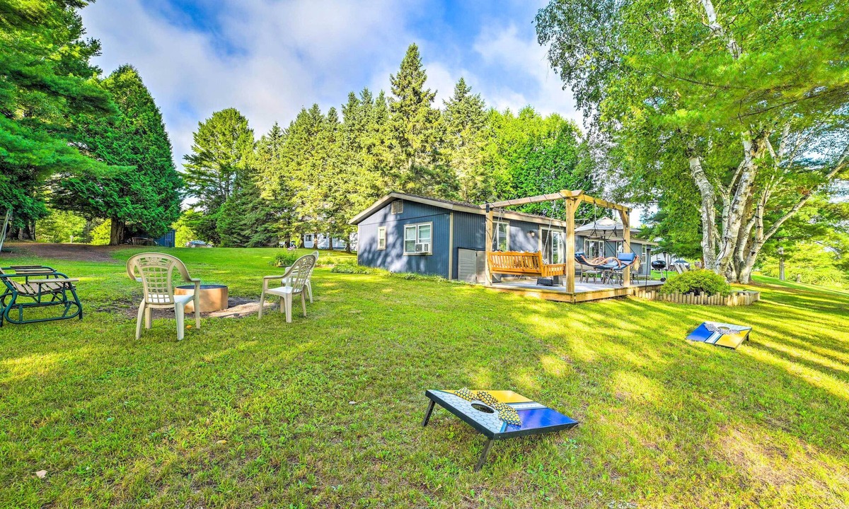 Cheboygan Cottage | Riverfront Home w/Dock ~ 6 Mi to Cheboygan!