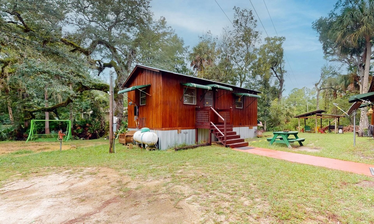 Bronson Cabin | Rustic riverfront cabin with views, firepit, grill, canoe, kitchen, & W/D