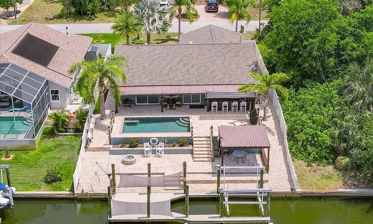 Palm Harbor House | Waterfront Retreat with Pool, Tiki Bar & Boat Dock