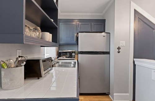 Lower Garden District Condo | Bright 1BR/2BA Garden District condo with wrap balcony, gated parking, pet-friendly, steps to Magazine