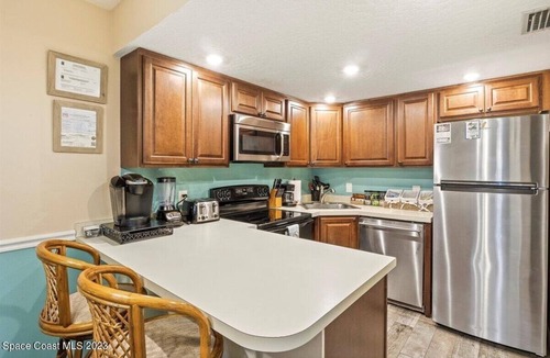 Chandler Park Condo | Cape Canaveral Oceanside Oasis - 1st floor with bikes and beach toys