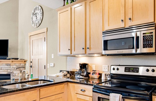 Three Lakes Condo | Lake-view condo with pool and hot tub access, jetted tub, firepit, and a balcony