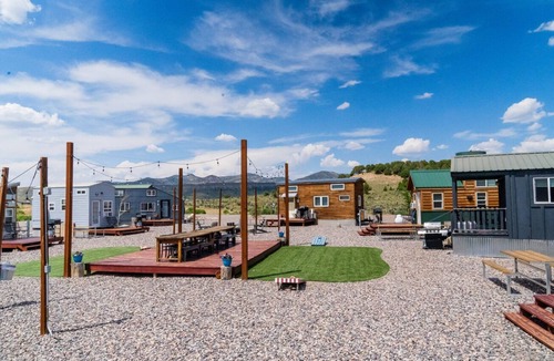 Meeker House | Lion Canyon was built by Mitchcraft in Fort Collins, Colorado as part of HGTV's "Tiny House Hunters". This home has two lofts, each with a Queen bed. One is accessible by stairs and one by ladder.