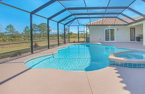 Grant-Valkaria House | Stunning Mediterranean-style vacation home w/ fabulous spillover hot tub/pool!