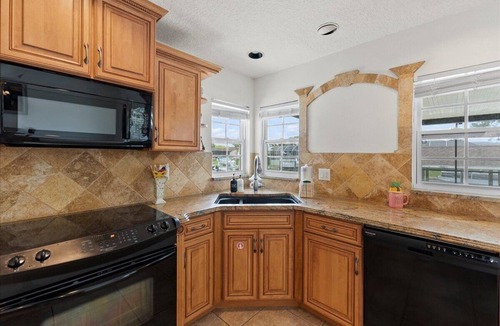 Palm Harbor House | Waterfront Retreat with Pool BBQ and Canal Views