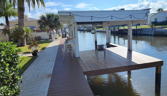 Intercostal channel house with boat dock and ping-pong table